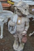 A garden ornament modelled as a young boy.