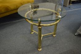 A brass and glass circular coffee table.