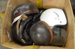 Various old crash helmets.