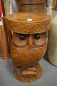 A carved wood owl pedestal or seat.