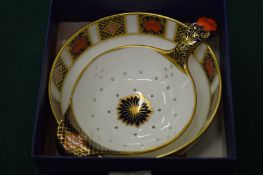 A Royal Crown Derby tea strainer and bowl, boxed.