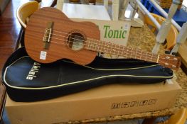 An ukulele with case, boxed and unused.