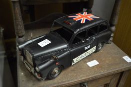 A novelty tin plate London taxi.