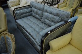 An unusual day bed, the frame with removable end supports, upholstered in a classical style button