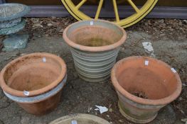 Three large terracotta plant pots.