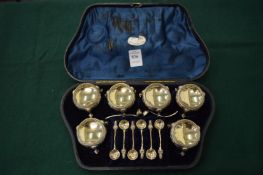 A good set of six silver plated salts with matching spoons, cased.
