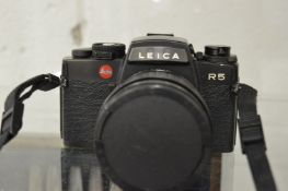 A Leica R5 camera with instructions.