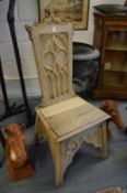 A pair of unusual Gothic Revival carved bleached oak hall chairs.