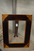 An inlaid mahogany photograph frame.
