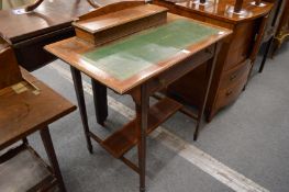 An Edwardian rosewood writing table.