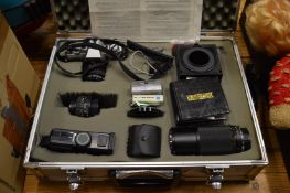 Aluminium camera case containing a Minolta X300SLR camera with accessories.