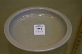 A Chinese celadon brush washer with incised decoration.