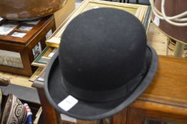 A bowler hat, internal size 19cm x 16cm.