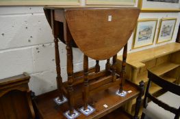 A small oak drop-leaf gate-leg dining table.