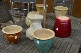 Six various garden pots and a stand.