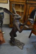 A large pair of bronze boxing hare statues.