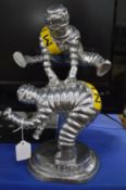 A cast metal Michelin man, Leapfrog group.