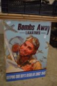 A novelty metal sign for 'Bombs Away Laxatives'.