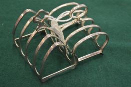 Two small silver toast racks.