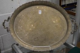 An Eastern silver plated oval twin handled tray with engraved decoration.