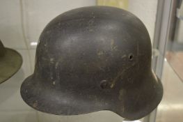 A German military helmet with leather liner.
