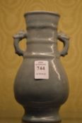 A small Chinese celadon glazed twin handled vase.