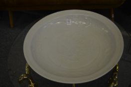 Large Chinese celadon bowl decorated with a dragon.