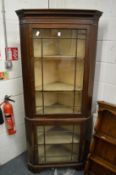 A mahogany two door standing display cabinet.