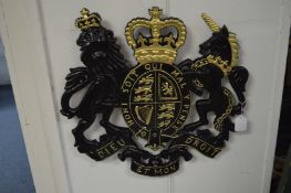 A painted cast metal coat of arms.