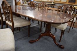 A good Georgian style mahogany twin pillar dining table with two leaves.