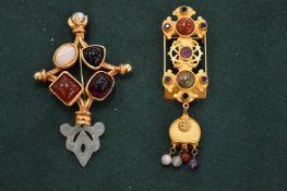 A Natasha Strambouli gilt metal and cabochon stone brooch together with another decorative brooch.
