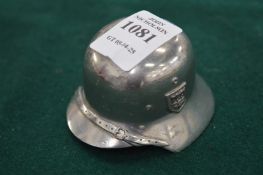 A cast metal model of a German helmet.
