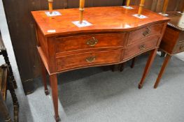 A four drawer serpentine fronted side table.