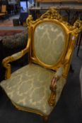 A good pair of decorative gilt framed open armchairs with classical style upholstery.