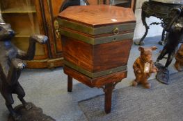 A George III mahogany and brass bound hexagonal shaped cellarette on stand.