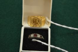 A decorative ring and a gilt metal ring.