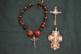 Three early crucifixes, one with amber bead rosary.