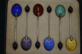A set of six silver and enamel coffee bean spoons, cased.