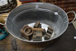 A galvanised tub and cast iron weights.