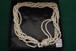 A six row fresh water pearl necklace with encrusted panther head clasp.