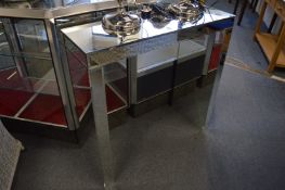 A mirrored console table.