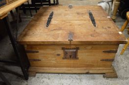 An old pine storage chest with two hinged flaps.