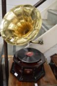 A reproduction gramophone with brass horn.