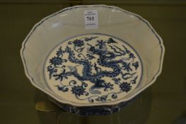 A Chinese blue and white dish, the centre decorated with a dragon.
