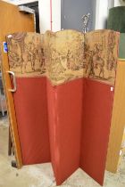 A fabric covered folding dressing screen.
