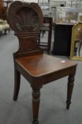 A 19th century carved mahogany hall chair.
