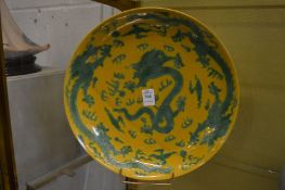 A Chinese famille jaune dish decorated with dragons.