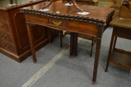 A Chippendale style mahogany serpentine outline fold-over tea table.