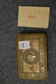 A Queen Mary Christmas tin containing the Christmas card.