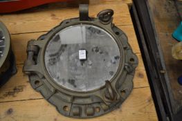 A cast bronze port hole converted to a mirror.